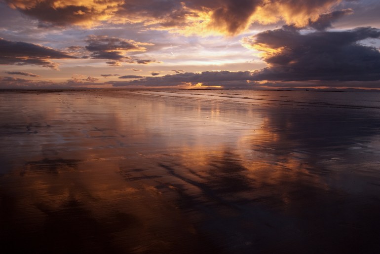 lots of subtle light varied in the way it is has dappled itself unequally across the sky and wet sand - somewhere in Moray - well you cant have all the details or you will be on my doorstep pinching my great sky's