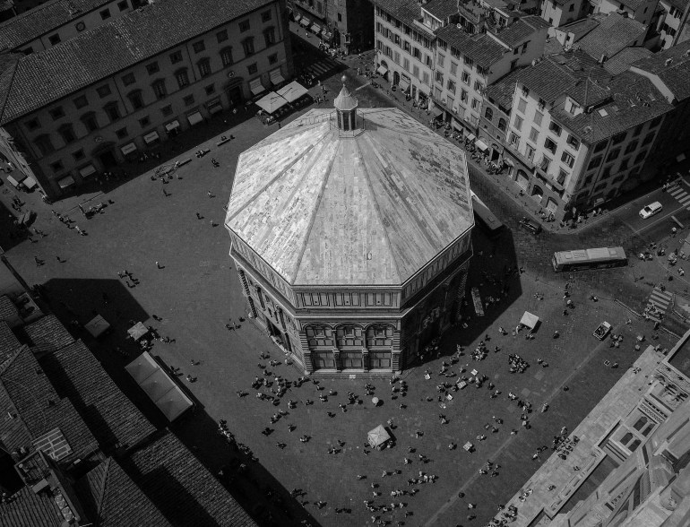 The Florence Baptistery or Battistero di San Giovanni (Baptistry of St. John) is a religious building in Florence (Tuscany), Italy, which has the status of a minor basilica. The octagonal Baptistry stands in both the Piazza del Duomo and the Piazza di San Giovanni, across from the Duomo cathedral and the Giotto bell tower (Campanile di Giotto). It is one of the oldest buildings in the city, built between 1059 and 1128. The architecture is in Florentine Romanesque style.