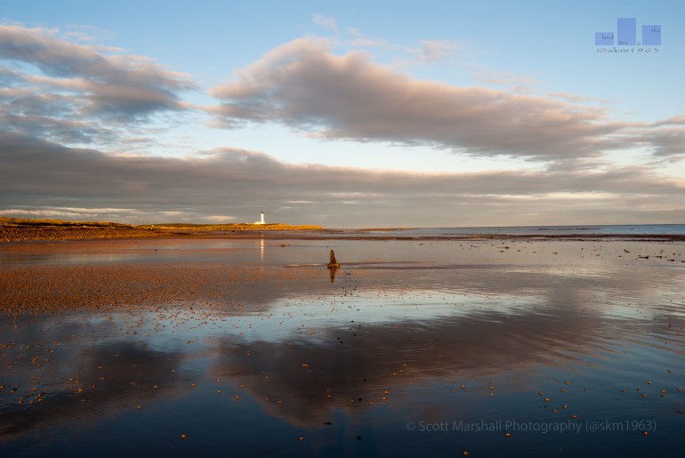 An exceptional morning on Lossiemouth West Beach, Covesea Lighthouse has just succumbed to the first light of the day.  The tide is full out offering a glass surface reflection.